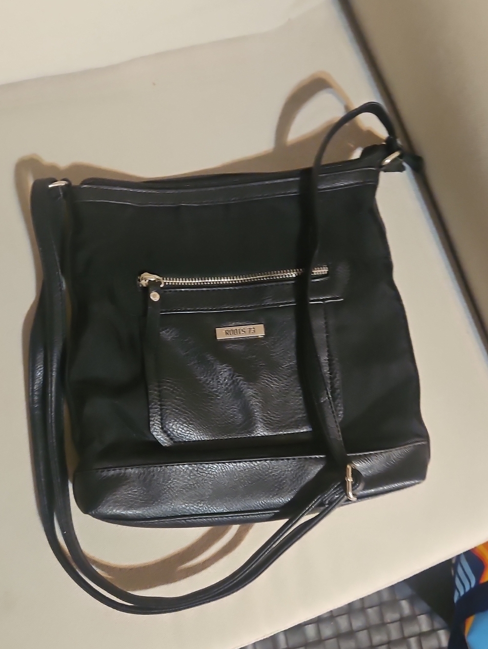 Roots Black Shoulder Bag with Front Zip Pocket